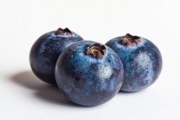 Obraz premium Three vibrant blueberries on a pristine white surface enhancing colors fresh appeal nutrition natural treat studio shot