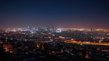 Fototapeta premium Nighttime view of Riyadh's skyline with glowing city lights.