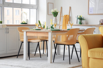 Dining table set for Easter with tulips in kitchen