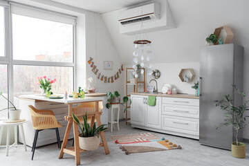 Interior of kitchen decorated for Easter with dining table and counters