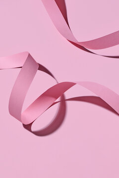 Curved Pink Ribbon on Minimalist Background