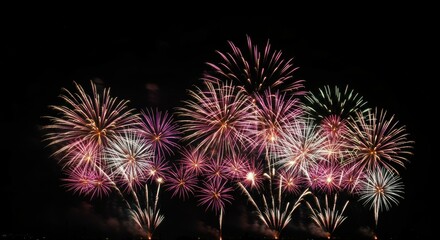 Fireworks display, night sky, colorful explosions, pyrotechnics, celebration, dark background, multiple bursts, golden and pink hues, festive atmosphere, aerial view, sparkling lights, new year's eve,