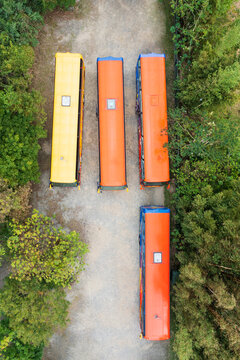 Aerial View School Buses Parked in Forest Line Formation Drone S