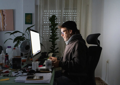  A man drinks tea while working