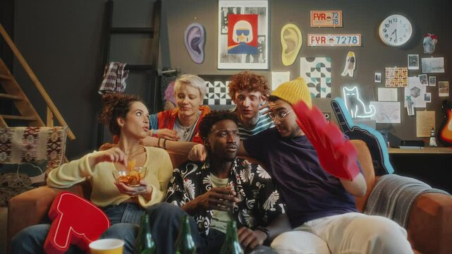Group of diverse friends sitting together on couch, enjoying snacks, watching comedy show on TV, chatting and laughing in trendy living room with modern decor. Zoom shot