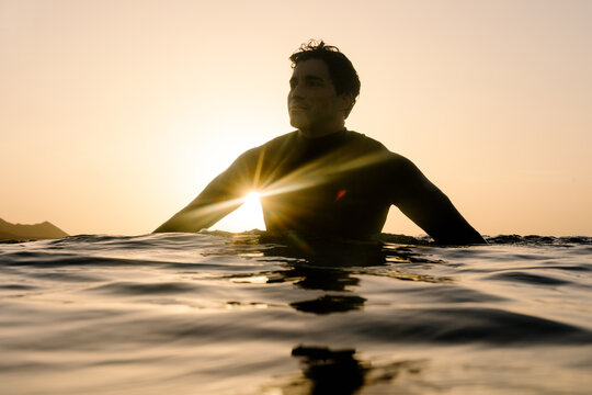 Surfer's outline gliding on the water's surface in Lanzarote at sunset