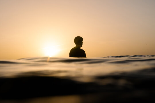 Silhouette of a surfer floating at Lanzarote's coast during a sunset