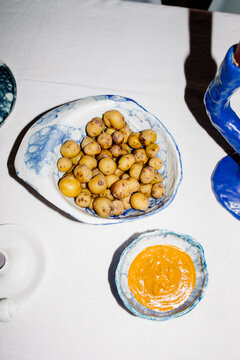 A bowl of Canarian potatoes with mojo, placed on a Spanish snack table