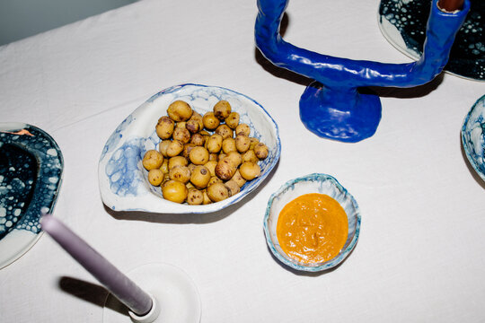 Detail lit with direct flash of a bowl of Canarian potatoes with mojo