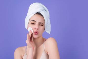 Beauty model cleansing her perfect skin by cotton pad sponge. Spa and wellness, skin care. Evening...