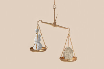 Golden vintage scales with white stones and silver coin