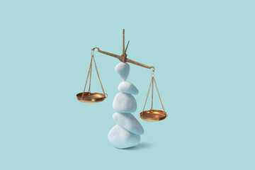 Empty golden scale balancing on stack of white pebbles