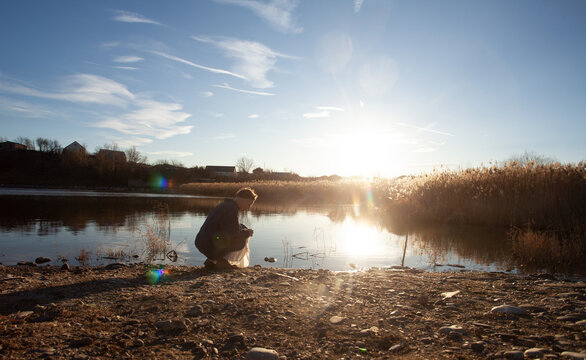 A woman at the lake in the sunlight 