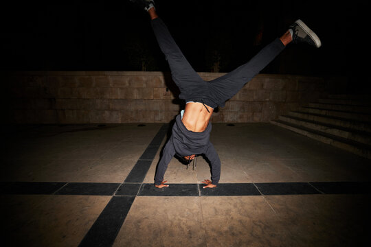 Man showcasing a dynamic backflip in an urban setting