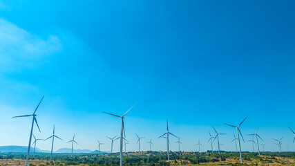 Fototapeta premium Wind farm on the mountain on blue sky day wind energy concept alternative energy Renewable energy 
