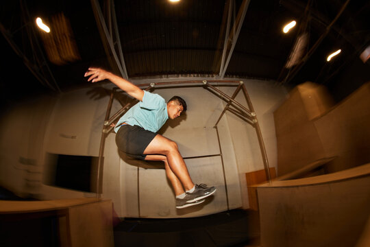 Athlete Mid-Jump on Bar during Training Session