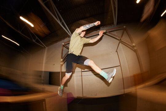 Athletic man jumping on bar during fitness training