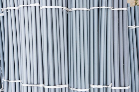 Bundled Gray PVC Pipes Construction Material Industrial Pattern