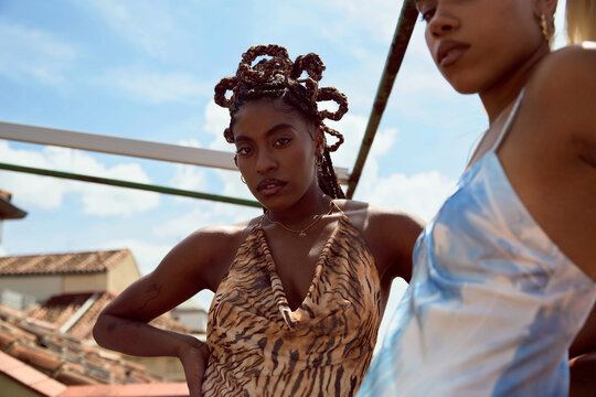 Portrait of young women wearing fancy dresses in rooftop