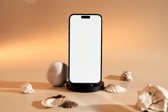 A mobile phone with white screen next to the shells