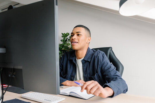 Entrepreneur enjoys a remote work session sitting at a desk at home