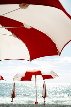 red and white umbrella on the beach on a sunny day
