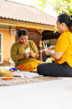 Balinese women preparing traditional offerings in Bali, Indonesia
