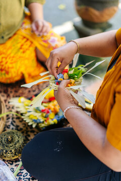 Balinese women preparing Canang sari, traditional offerings in Bali