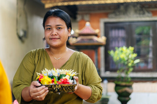 Balinese woman preparing Canang sari, traditional offering