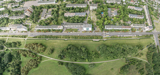 public city park near residential district. green trees and lawns with footpaths. summer time. panoramic aerial view.