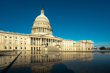 Capitol dome in Washington, DC. The state capitol buildings in Washington, DC. The Congress in Washington, DC. American flag waving. The Capitol Hill in Washington, DC.
