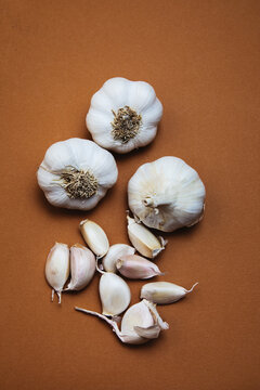 Garlic Bulbs and Cloves on Brown Surface