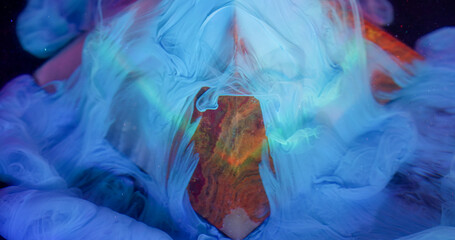Ink spread. Acrylic stream. Pyramid stone onyx shape blue pigment pour slide black background underwater abstract art blur rainbow light ray.