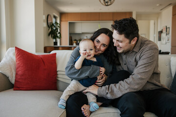 Cheerful Family Sitting Together Enjoying Time Indoors on the Couch