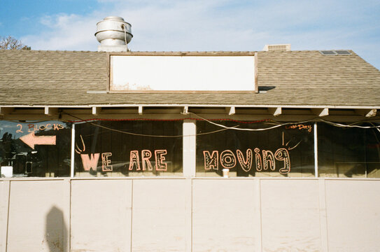 We are moving - message written on a vacant business  