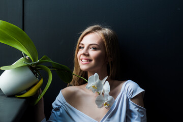 Sensual model portrait. Sexy portrait of tender beauty woman with orchid. Passionate model. Sensual...
