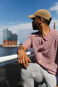 Man Looking at Waterfront Cityscape from Ferry