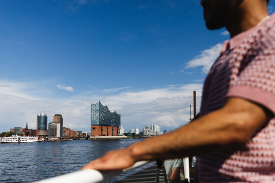 Urban Waterfront with Modern Architecture and Person on Ferry in