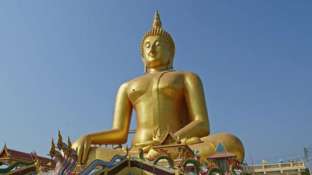 Blue sky above the great Buddha of Thailand at wat Muang Ang Thong Thailand. 
The largest Buddha statue in the world can be seen from afar