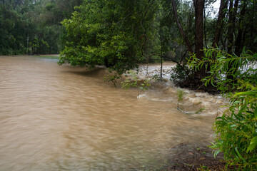 An otherwise green park is inundated with water as a nearby creek bursts it's banks during a flood