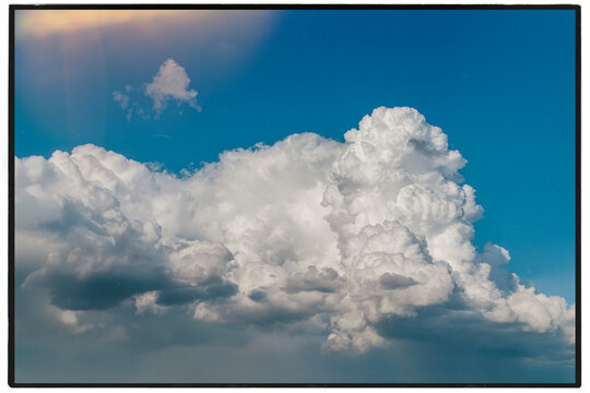 Majestic cumulus clouds in a vibrant blue sky during a sunny day.