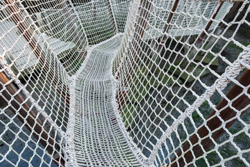 Suspended Rope Bridge with Intricate White Netting