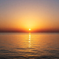 sunset over the sea. a peaceful sunrise as first rays of light emerge over horizon illuminating calm sea.