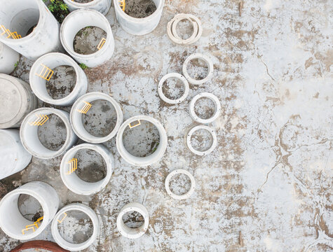 Top View of Concrete Pipes and Drainage Equipment on Ground