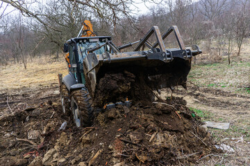 A backhoe loader moves earth
