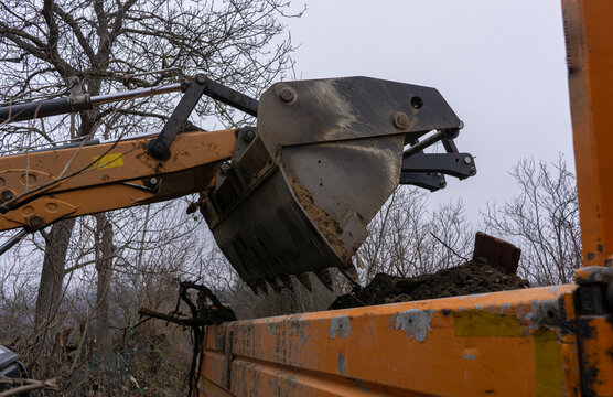 A backhoe loader moves earth