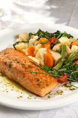 Grilled salmon with vegetables on plate