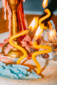 Colorful candles create vibrant patterns on a festive table