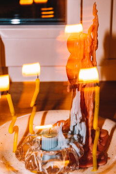 Colorful candles flicker around a unique sculptural centerpiece