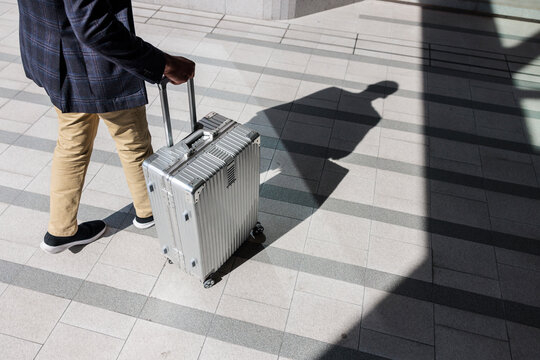 High angle view of professional walking with suitcase